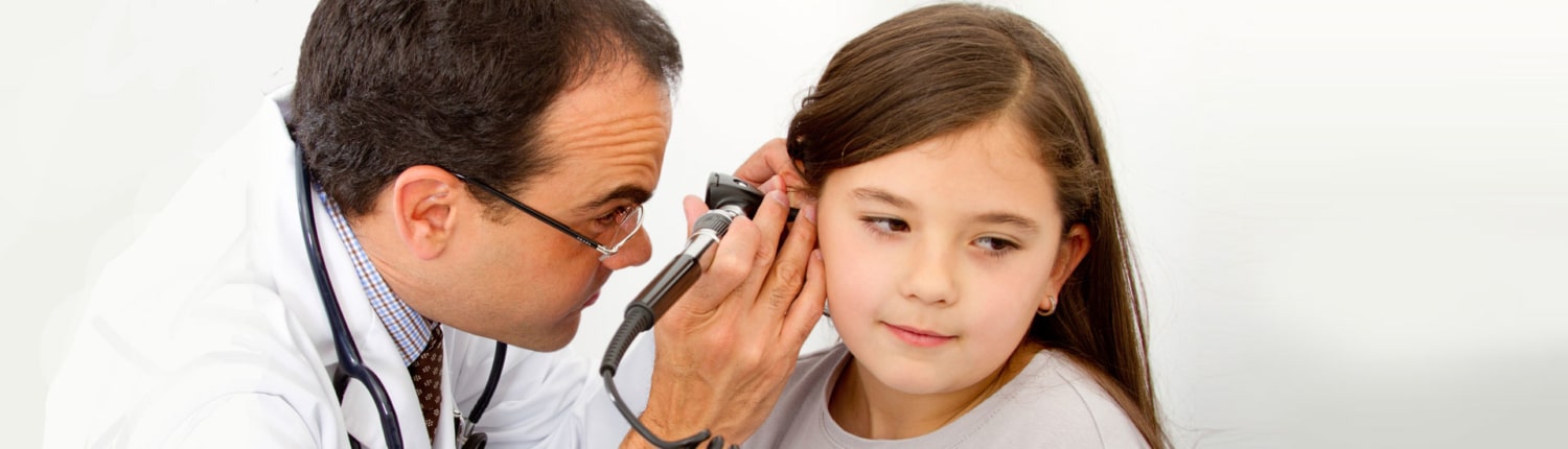 Doctor checking child's ear